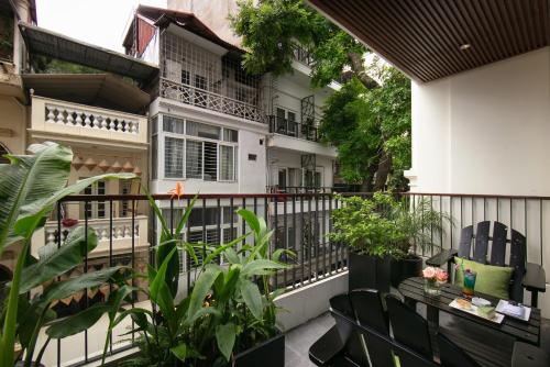 a balcony of a house with plants and a fence at Le Premier Hotel & Rooftop Bar in Hanoi