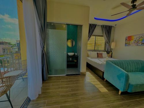 a bedroom with a bed and a couch and a balcony at PHỐ CHỢ ĐÊM Villa - Near Hoi An Old Town 200m in Hoi An