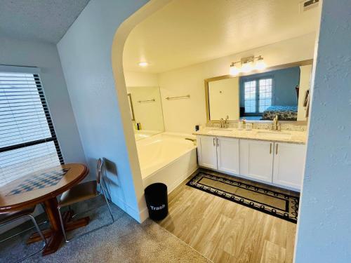 a bathroom with a tub and a sink and a bath tub at Cute 2 Bedroom 2 Bath 2 mile Strip5 in Las Vegas