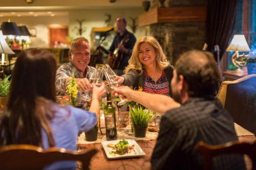 a group of people sitting around a table drinking wine at The Hotel Telluride in Telluride