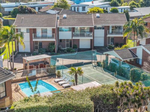 an aerial view of a house with a tennis court at Anchorbell Apartments Merimbula in Merimbula