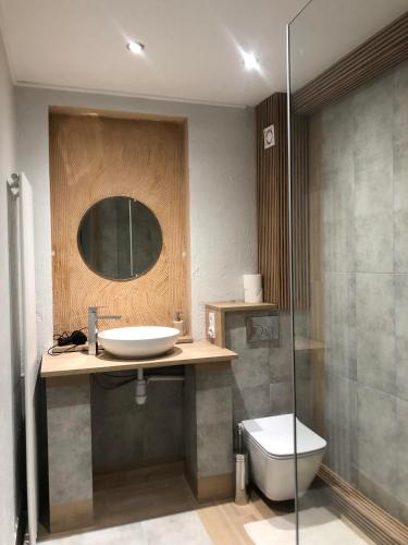 a bathroom with a sink and a toilet and a mirror at Jedliczanka in Jedlicze
