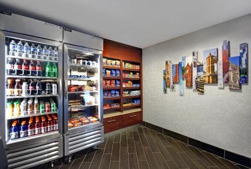 a refrigerator filled with lots of drinks in a store at Holiday Inn Express & Suites Cincinnati Riverfront by IHG in Covington