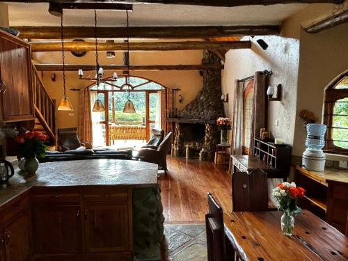 a kitchen with a table and a living room at Magical Malewa Retreat in Naivasha
