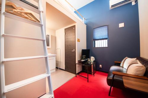a living room with a couch and a ladder in a room at LOCO Minamiichi in Nara