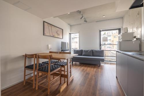a kitchen and living room with a table and a couch at 67 Apt Kagurazaka Premium in Tokyo
