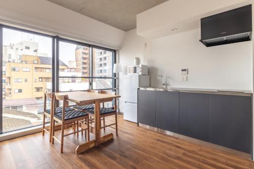 a kitchen with a table and a large window at 67 Apt Kagurazaka Premium in Tokyo