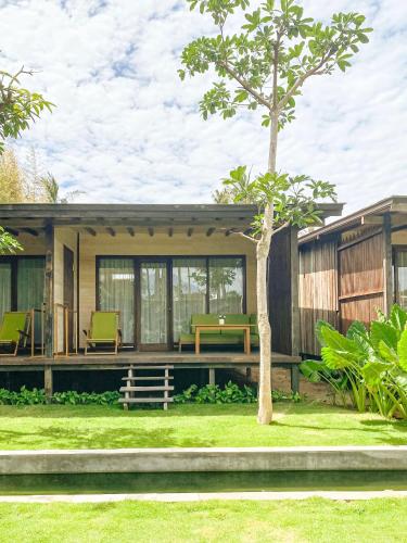 a modern house with a green yard at Villa So Long Banyuwangi - Ijen in Banyuwangi