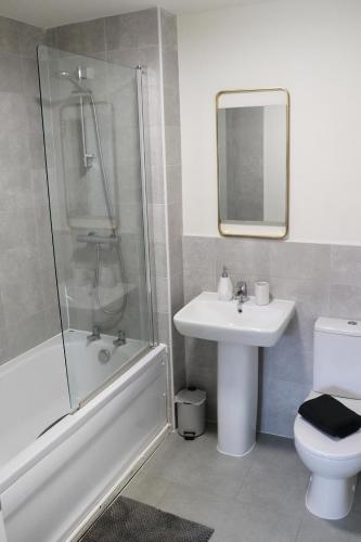 a bathroom with a sink and a shower and a toilet at Modern 3-Bedroom - VAT Included - Private Drive Parking in Stafford
