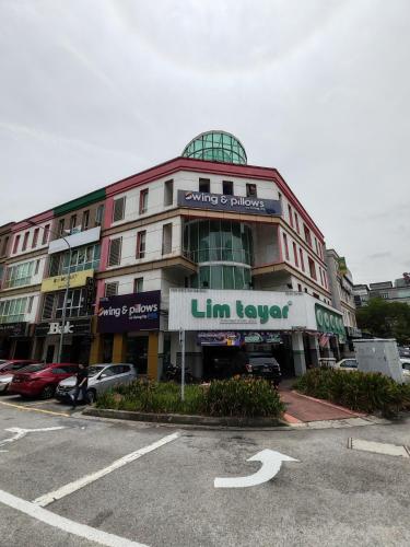a building with a sign on the front of it at Pillows Plus Kota Damansara in Kota Damansara
