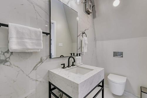 a white bathroom with a sink and a mirror at Stardust Big Bend Luxury A-Frame#4 great views in Terlingua
