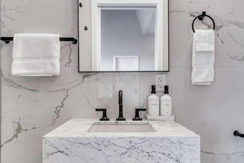a white bathroom with a sink and a mirror at Stardust Big Bend Luxury A-Frame#4 great views in Terlingua