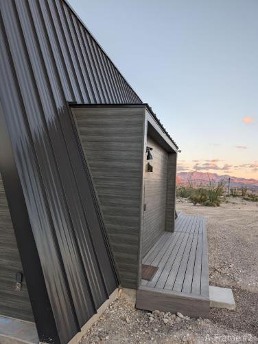 a building with a wooden door on the side of it at Stardust Big Bend Luxury A-Frame#4 great views in Terlingua