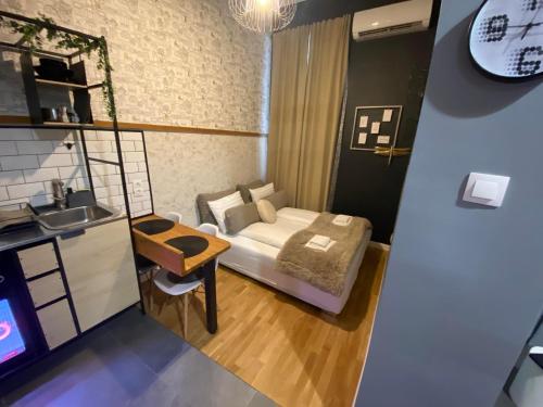 a small room with a bed and a sink at Walk Inn Váci 78 in Budapest