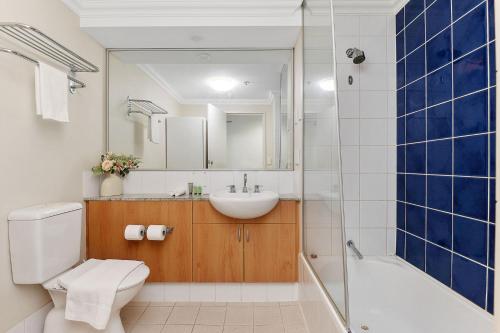 a bathroom with a toilet and a sink and a shower at Central City Living Murray Street Studio in Perth