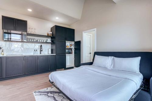 a bedroom with a large bed and a kitchen at Stardust Big Bend Luxury A-Frame#10 with a fab view in Terlingua