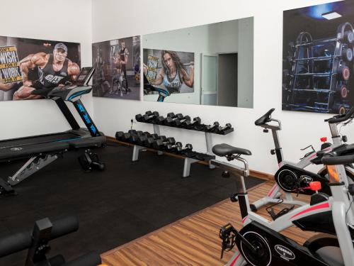 a gym with exercise equipment and a mirror at Corundum Breeze Negombo in Negombo