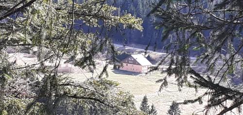 a house in the middle of a snow covered field at Domaine Des Hauts Viaux in La Bresse