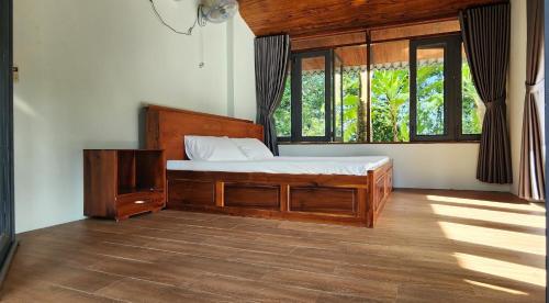 a bedroom with a bed and a window at An Nhien Garden in Long Khanh