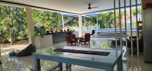 a living room with a table and a dining room at An Nhien Garden in Long Khanh