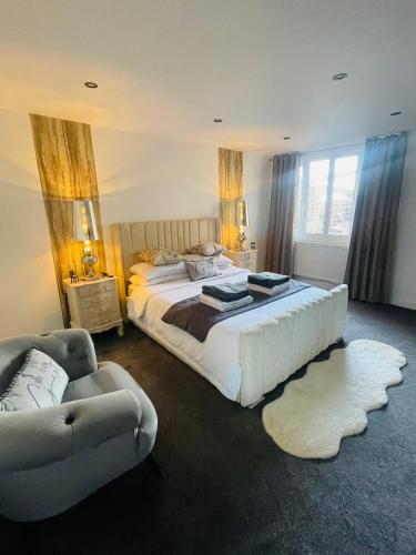 a bedroom with a large bed and a couch at Secret Cabin Getaway in Hartlepool