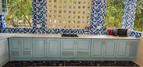 a kitchen with blue and white tiles and a counter at An Nhien Garden in Long Khanh