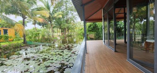 a house with a pond filled with water lilies at An Nhien Garden in Long Khanh