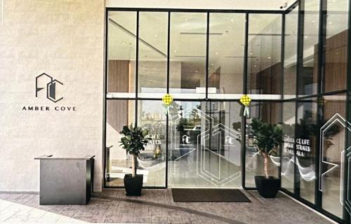 an entrance to an office building with glass doors at 马六甲 Melaka Amber cove residence Jonker Street in Melaka