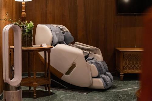 a white reclining chair sitting next to a table at Inhouse Hotel Grand in Taichung