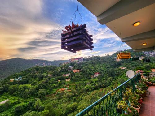 a view of a city from a balcony at Rashmi Cottage - 4 BHK Villa with Serene Valley Views in Dagshai