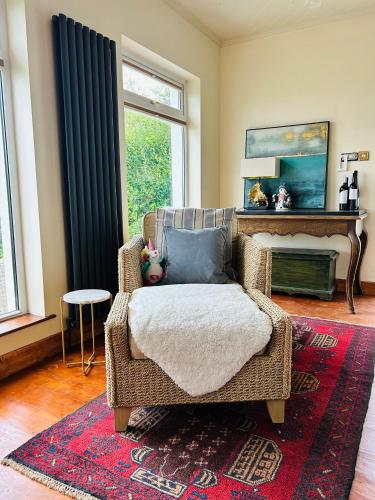 a living room with a chair and a fireplace at Marys House in Carrigart