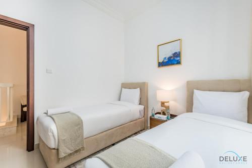 a hotel room with two beds and a mirror at Deal of the Week 4BR with Pool, Sea & Mountain Views by Deluxe Holiday Homes in Sharm