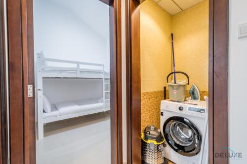 a laundry room with a washing machine and a washer at Deal of the Week 4BR with Pool, Sea & Mountain Views by Deluxe Holiday Homes in Sharm