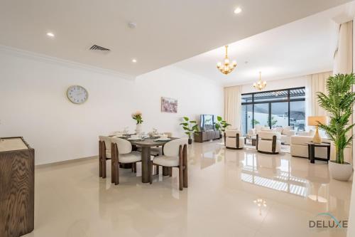 a dining room and living room with a table and chairs at Deal of the Week 4BR with Pool, Sea & Mountain Views by Deluxe Holiday Homes in Sharm