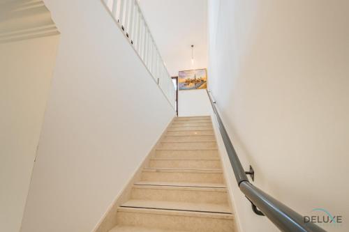 a staircase in a building with a painting on the wall at Deal of the Week 4BR with Pool, Sea & Mountain Views by Deluxe Holiday Homes in Sharm