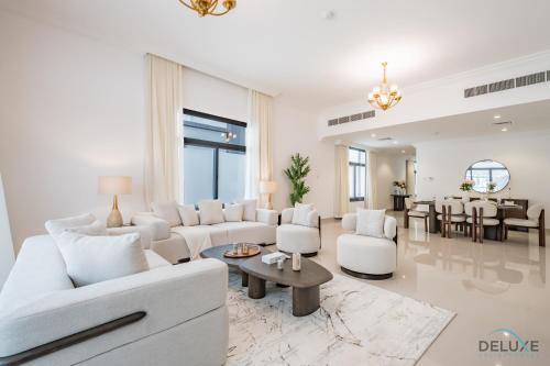 a living room with white furniture and a table at Deal of the Week 4BR with Pool, Sea & Mountain Views by Deluxe Holiday Homes in Sharm