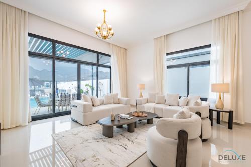 a living room with white furniture and a large window at Deal of the Week 4BR with Pool, Sea & Mountain Views by Deluxe Holiday Homes in Sharm
