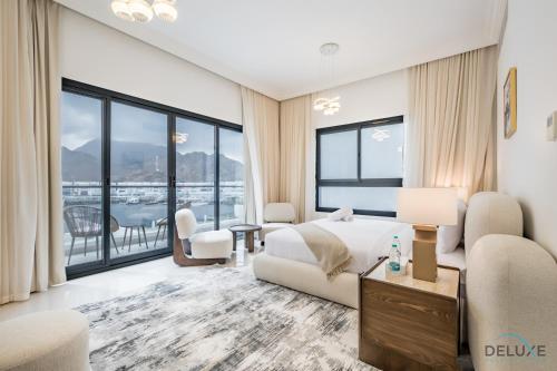 a bedroom with a bed and a large window at Deal of the Week 4BR with Pool, Sea & Mountain Views by Deluxe Holiday Homes in Sharm
