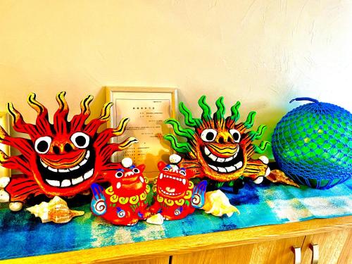 a group of monsters sitting on top of a counter at ほんだけ in Ishigaki Island