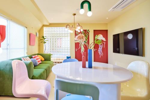 a living room with a table and a couch at 寅ホテル 御徒町 TORA HOTEL Okachimachi in Tokyo