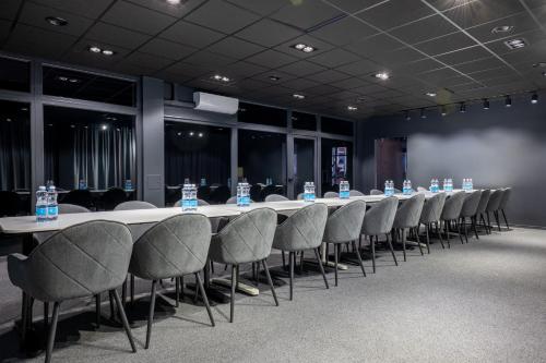 a conference room with a long table and chairs at Luna Self Check-in Hotel Klaipeda in Klaipėda