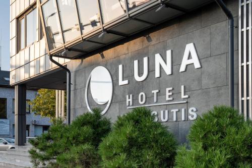 a hotel sign on the side of a building at Luna Self Check-in Hotel Klaipeda in Klaipėda