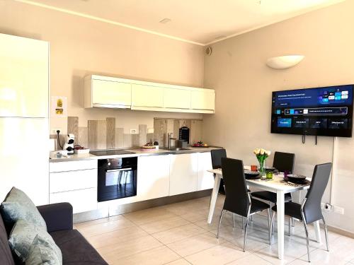 a kitchen and dining room with a table and chairs at ROMA ARCHAEOLOGICAL PARK Apartment in Ostia Antica