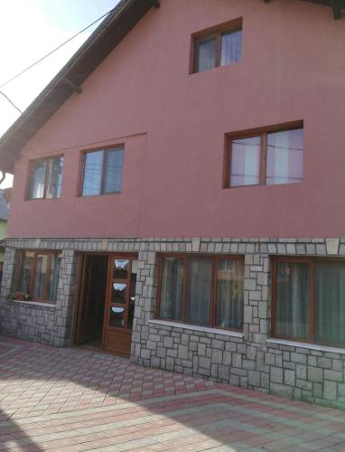 a red brick building with a door and windows at VILA Jo in Brebu