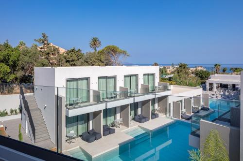 an image of a building with a swimming pool at Phos Hotel Adults Only in Plataniás