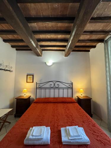 a bedroom with a bed with two towels on it at Affittacamere La Mattonata in Città di Castello
