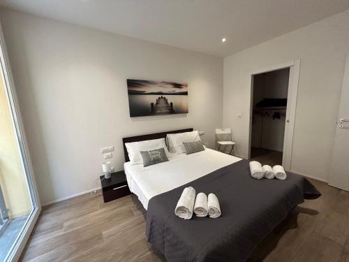 a bedroom with a bed with white shoes on it at Ariosti 3 - Piazza Maggiore in Bologna