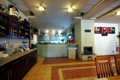 a kitchen with a bar and a counter in a restaurant at Penzión ZIVKA in Závažná Poruba