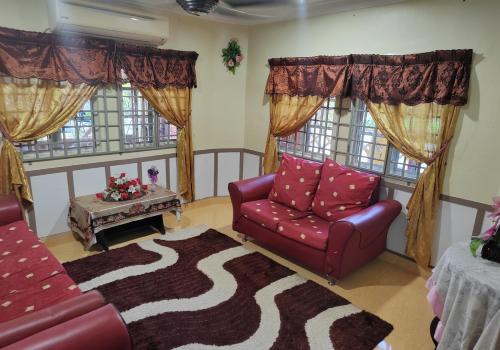 a living room with a couch and a table at Iltizam Homestay in Kuala Berang