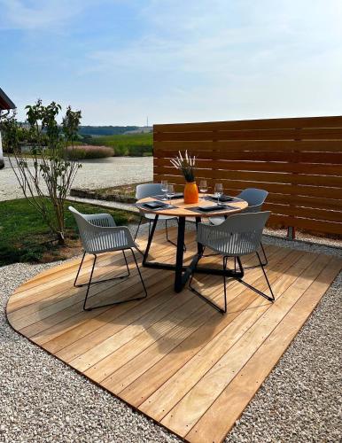a table and chairs sitting on a wooden deck at Luxeriöse Auszeit im Dreiländereck in Château-Rouge